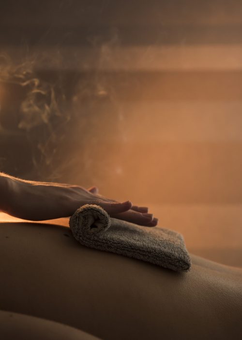 close-up-therapist-hand-massaging-woman-s-back-with-hot-towel-spa (1)
